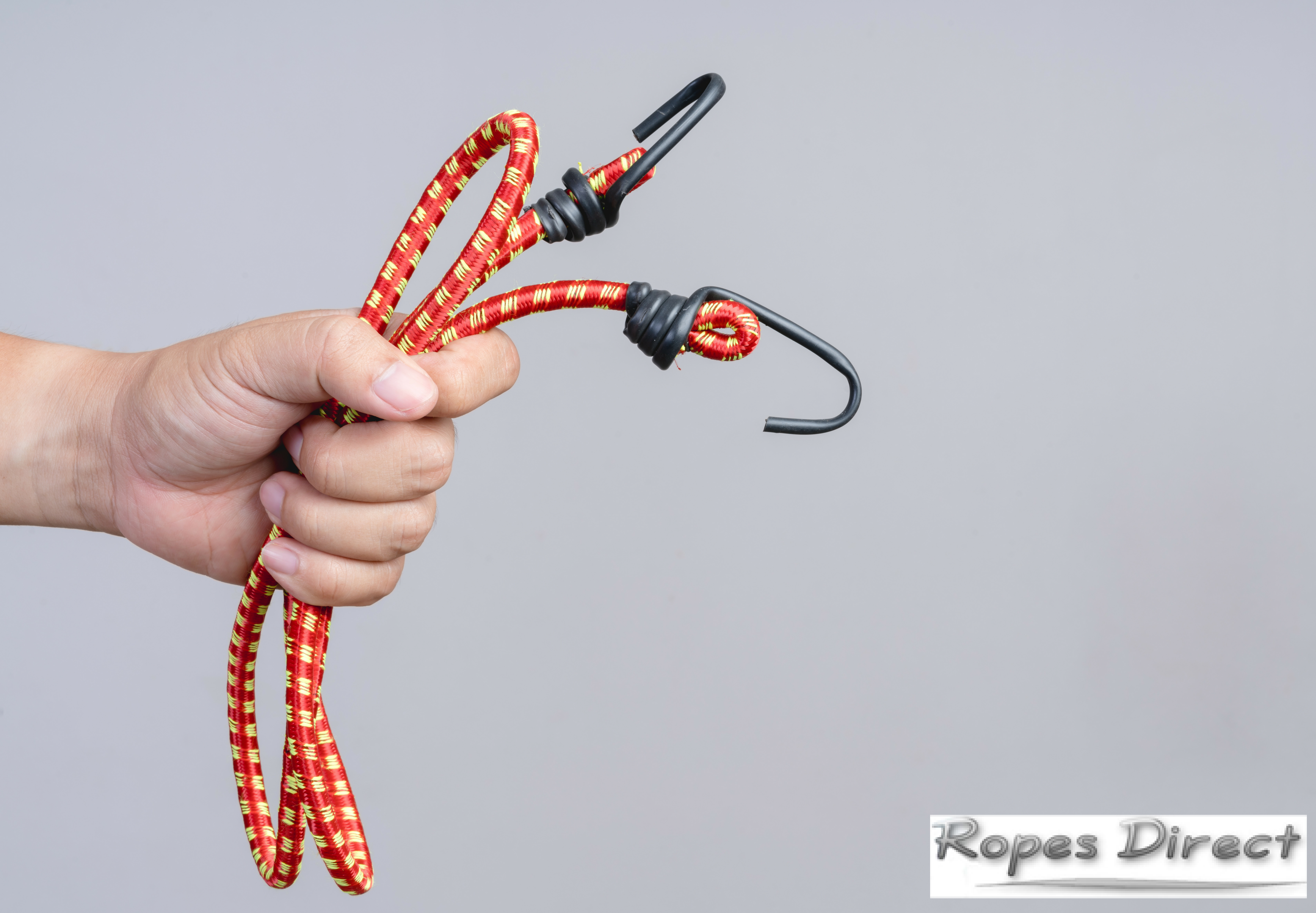 Person holding bungee cord with J-shaped hooks