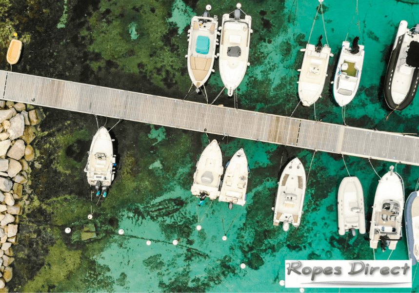 boats moored in a harbour using mooring ropes