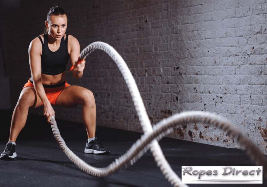 Woman using manila rope for exercise