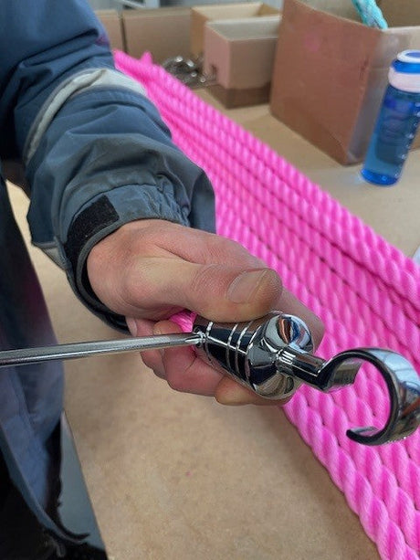 Fitting a hook on to a pink Polysilk barrier rope