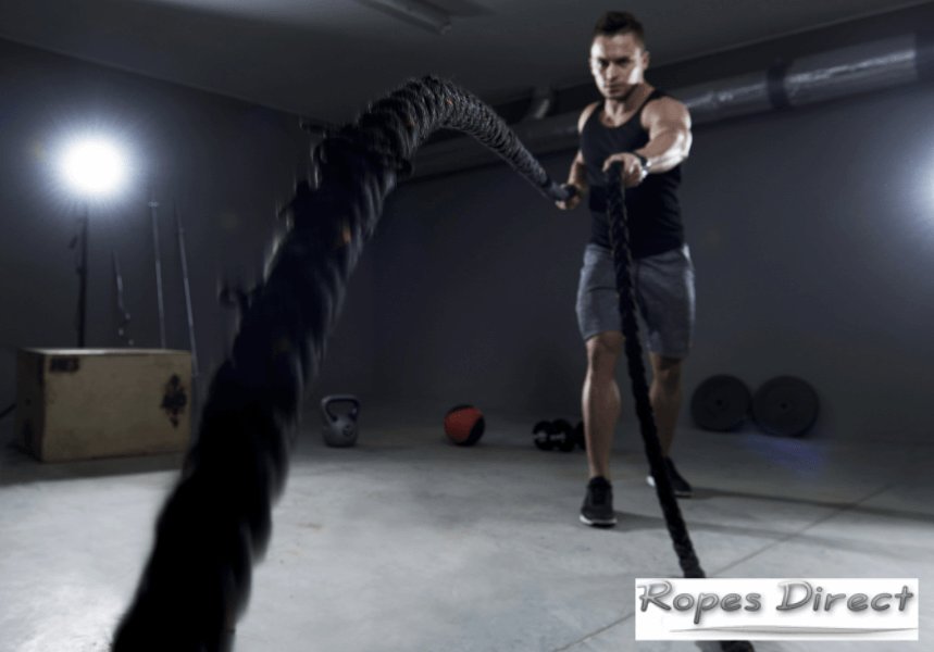 Man using battle ropes at home