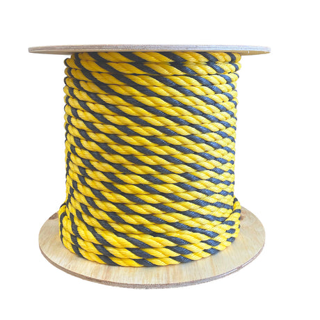 Spool of yellow and black striped rope on a white background