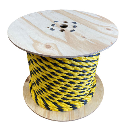 Spool of yellow and black striped rope on a white background