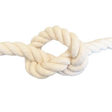 close-up of cream coloured natural cotton rope in a knot on a white background