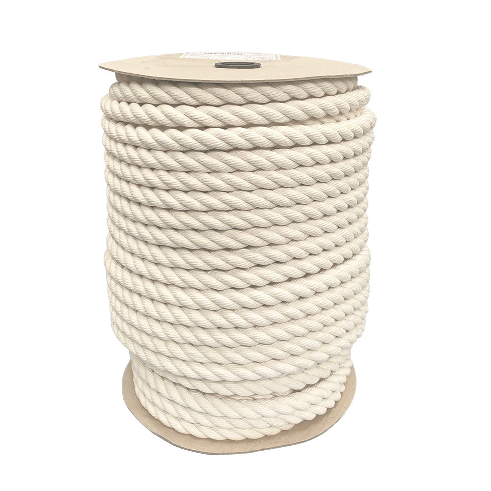 spool of 24mm natural cotton rope on a cardboard reel on a white backgound.