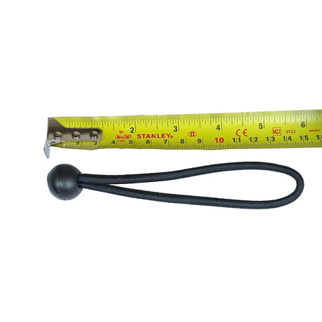 Black bungee cord in a loop with a black ball alongside a yellow tape measure on a white background