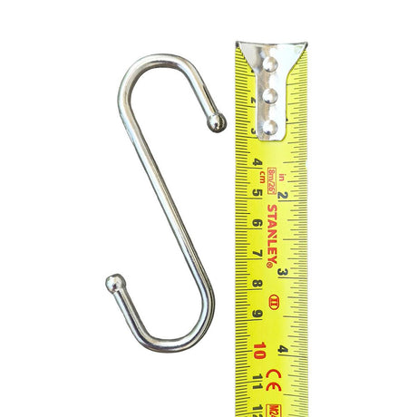 Metal S-hook next to a yellow Stanley ruler on a white background