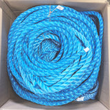Coils of bright blue and light blue twisted rope stored inside a cardboard box, viewed from above.