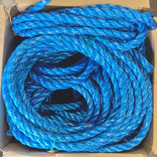 Coils of bright blue twisted rope sitting inside a cardboard box.