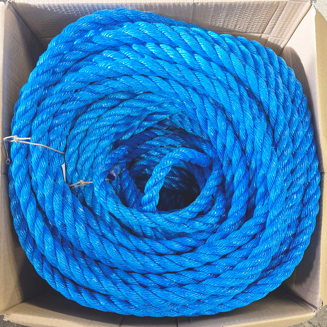Coils of bright blue rope sitting inside an open brown cardboard box.