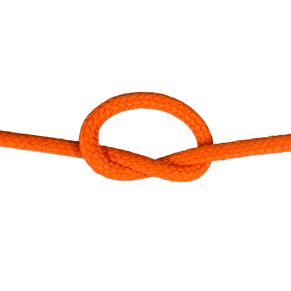 Close-up of 6mm orange magcians cord in a knot with a white background