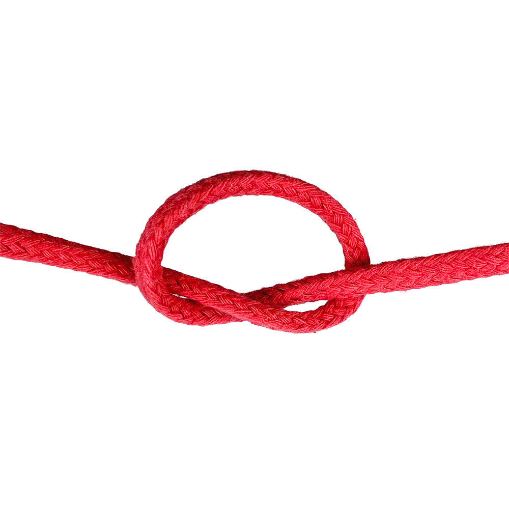 Close-up of 6mm red magcians cord in a knot with a white background