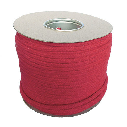 Spool of 12mm red magicians cord on a cardboard reel with a white background