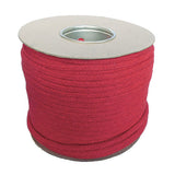 Spool of 12mm red magicians cord on a cardboard reel with a white background