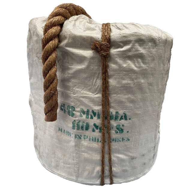 A 110m coil of 48mm Manila rope in white hessian wrapping, with a tail of rope looped over the top. From RopesDirect