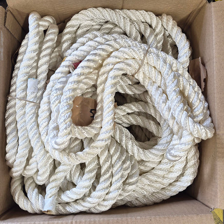 A bulk coil of thick, twisted white nylon rope packed inside a brown cardboard box.
