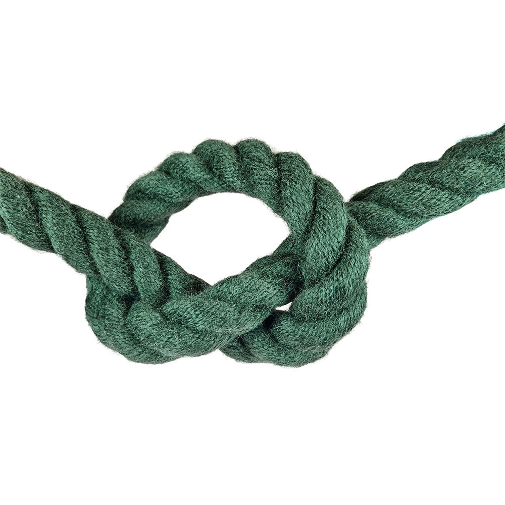 Green barrier rope in a knot on a white background