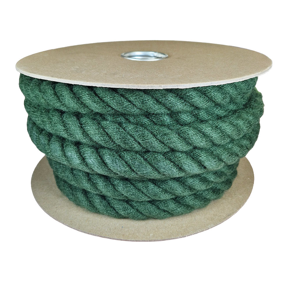 Spool of green rope on a cardboard reel with a white background