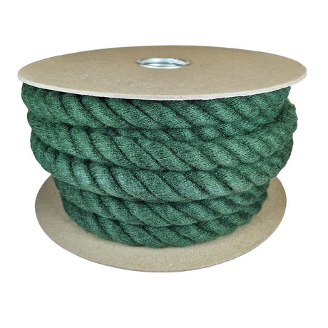 Spool of green rope on a cardboard reel with a white background