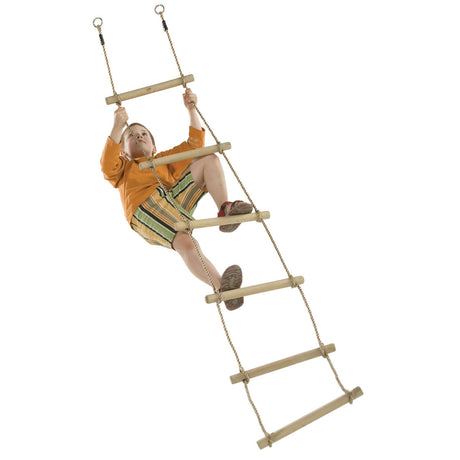 A child wearing an orange shirt and green-and-yellow striped shorts climbs a wooden rope ladder against a plain white background.