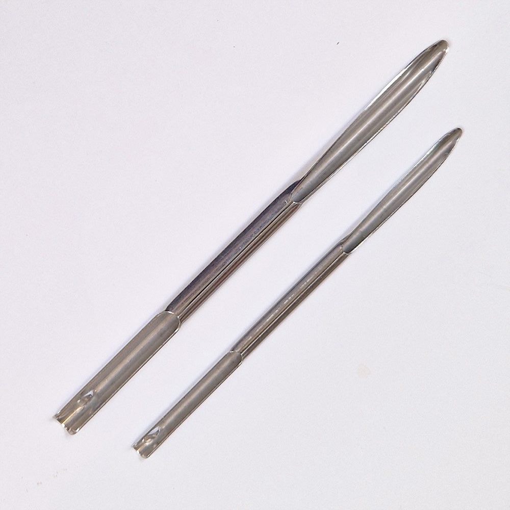 Two metal selme needles on a white background
