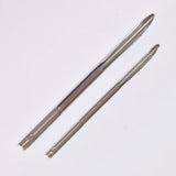Two metal selme needles on a white background