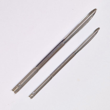 Two metal selme needles on a white background
