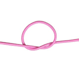 Close-up of pink bungee cord in a knot on a white background