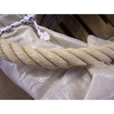 Close-up of a natural brown rope on a white cloth tied with a blurred background