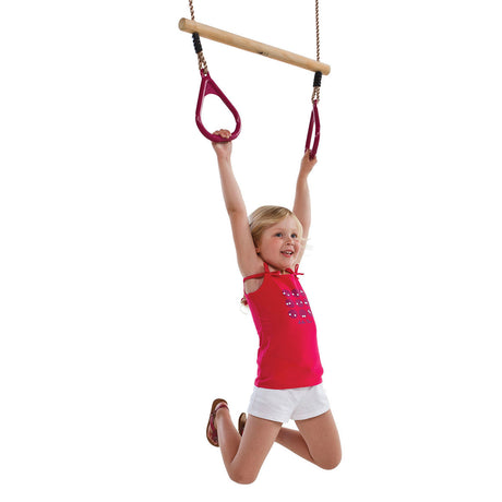 Child using a hardwood trapeze bar with plastic rings on a white background.