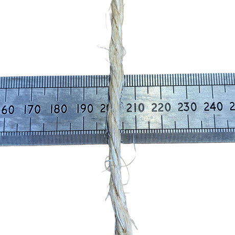 A close-up of a sisal rope, running vertically down the centre of a metal ruler on a white background, to show thickness.