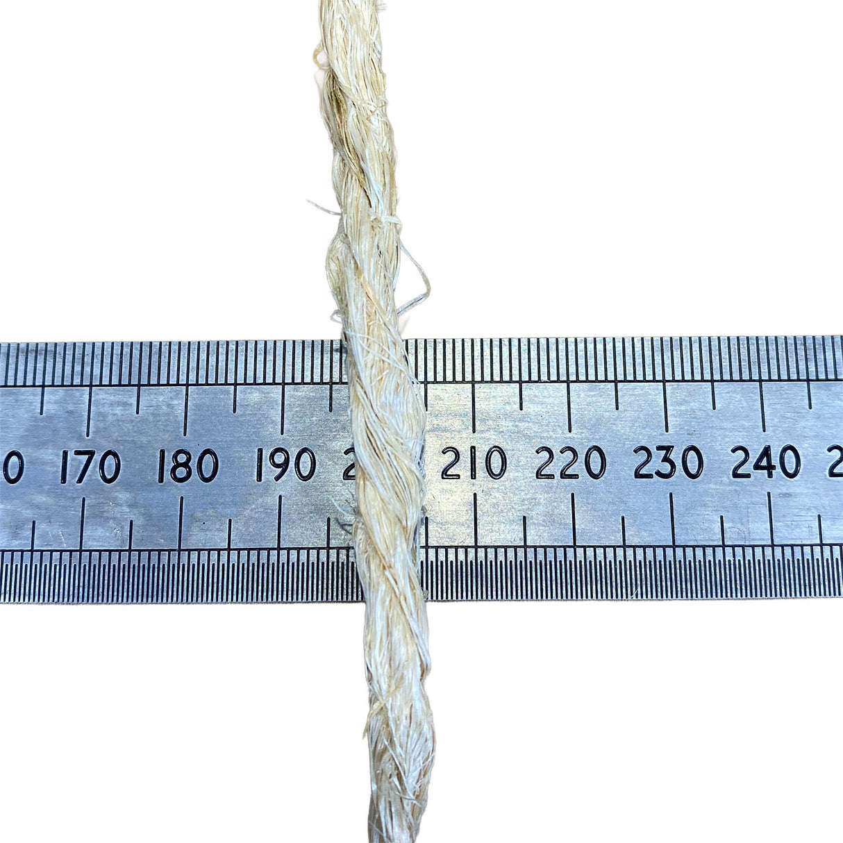 A close-up of a sisal rope, running vertically down the centre of a metal ruler on a white background, to show thickness